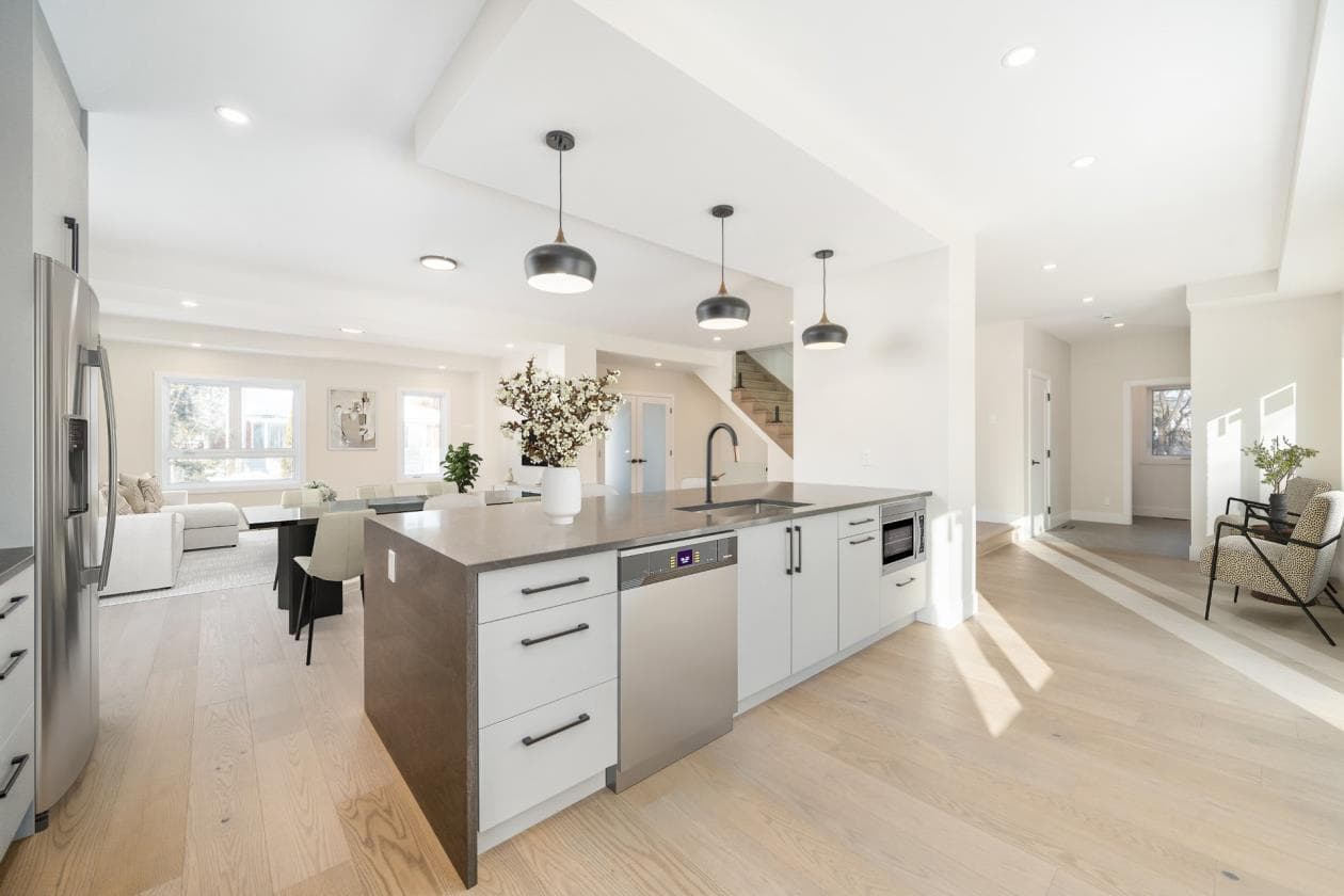 Cuisine ouverte blanche avec îlot en quartz béton et suspensions dôme